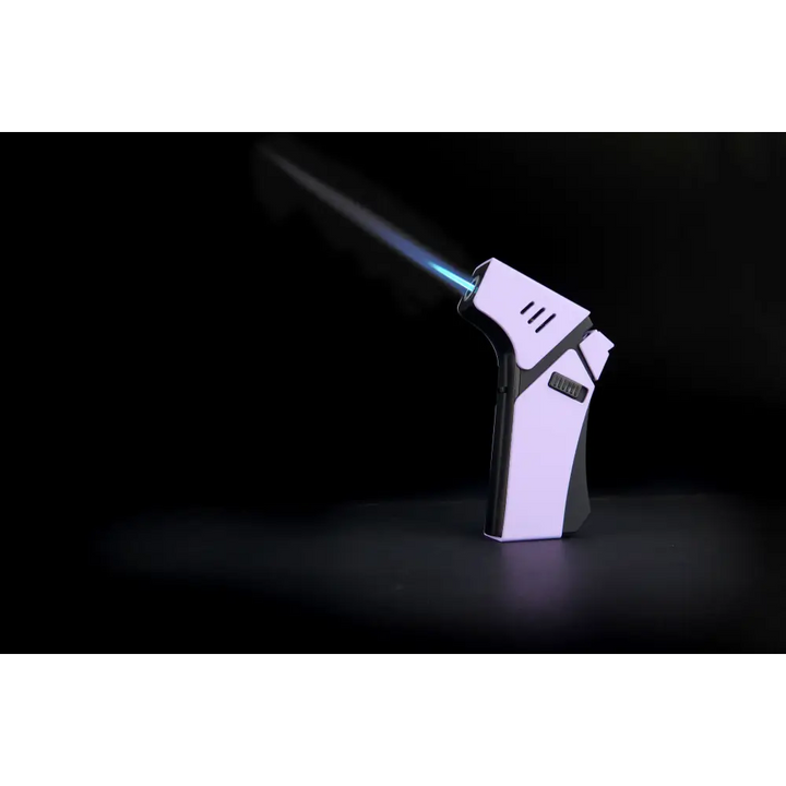 A purple and black torch lighter with a bright blue flame shooting out of its nozzle, angled upwards against a dark background.