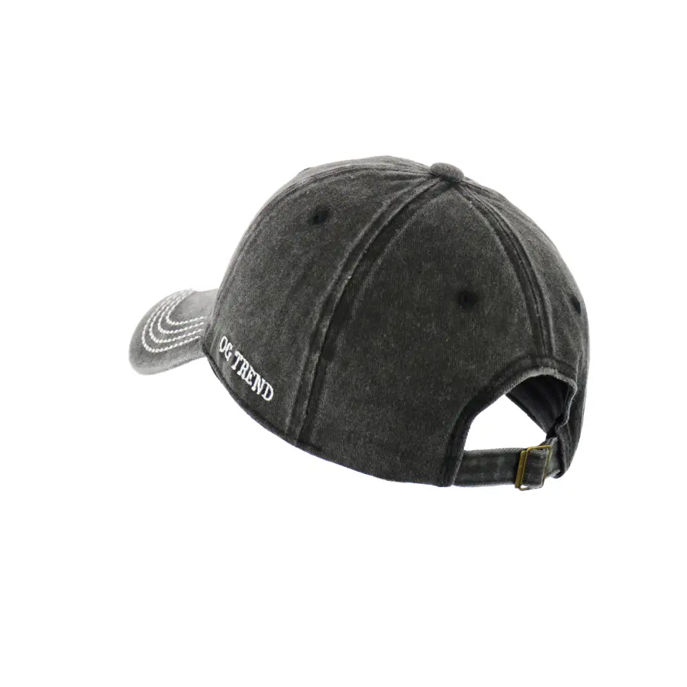 Back-side view of a dark grey distressed baseball cap with white embroidered text 'OG TREND' on the left side and a metal buckle adjustment strap visible at the back.