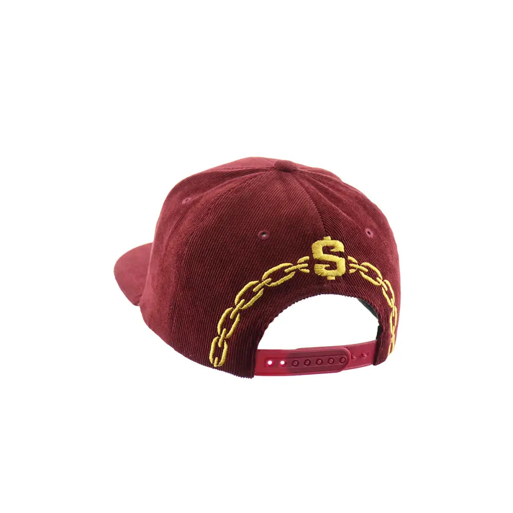 Rear view of a maroon corduroy snapback hat, featuring a gold embroidered dollar sign and chain design across the back, with a red adjustable snap closure.