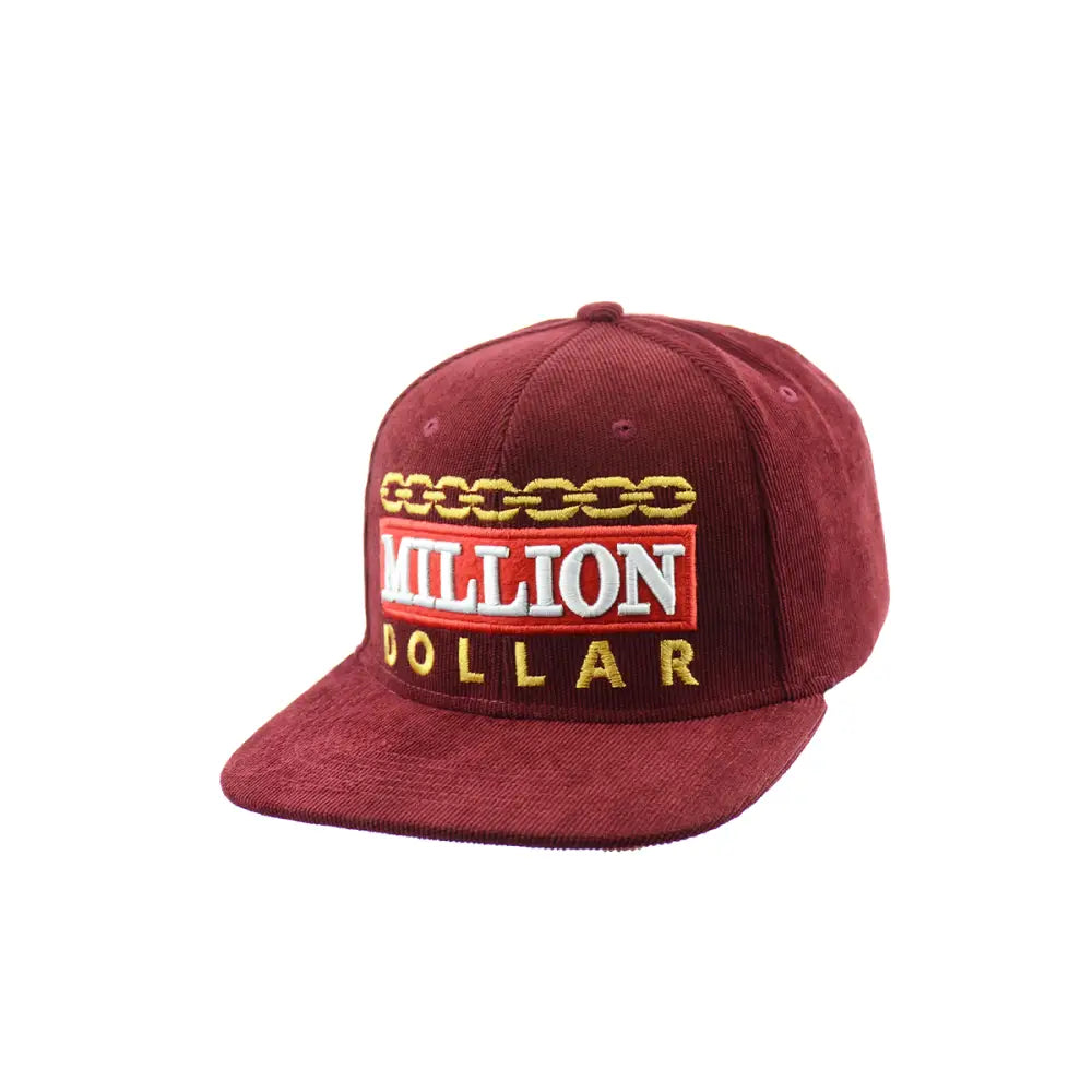 A maroon corduroy snapback hat featuring 'MILLION DOLLAR' embroidered in white and gold, with a gold chain design above the text.