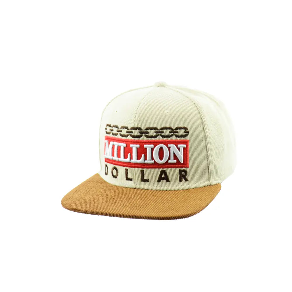 A cream-colored snapback hat with a brown corduroy brim. The front features embroidered text in red and black, reading 'MILLION DOLLAR' with a chain design above it.