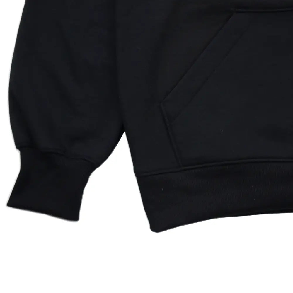 Close-up detail shot of the left sleeve cuff and the lower right portion of the kangaroo pocket on a plain black hoodie, against a white background.