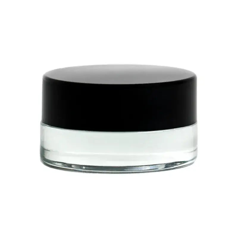 Close-up of a small, clear glass jar with a solid black screw-on lid, presented against a clean white background.