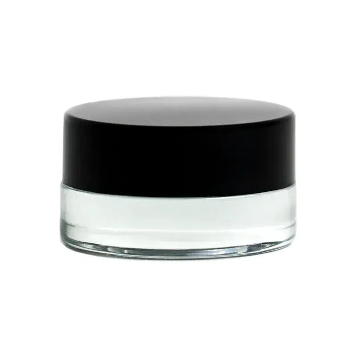 Close-up of a small, clear glass jar with a solid black screw-on lid, presented against a clean white background.