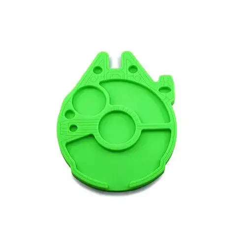 A bright green silicone dab tray station, shaped like the Millennium Falcon, featuring various circular depressions and raised lines on its surface.