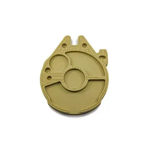 Close-up view of a tan silicone dab tray, intricately molded to resemble the Millennium Falcon spaceship, showcasing its various compartments and surface details.