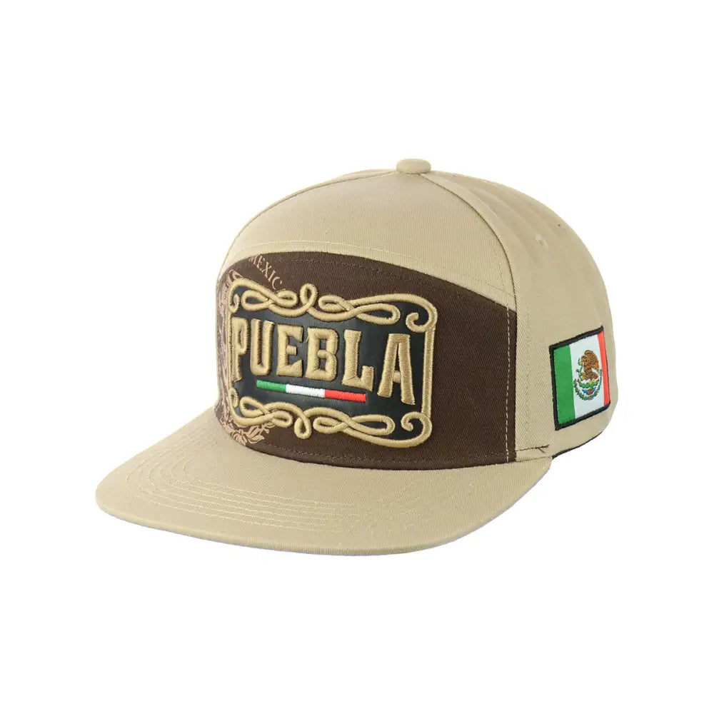 Angled view of a beige and brown snapback hat featuring 'PUEBLA' embroidered in gold with a Mexican flag design on the front panel, and a small Mexican flag patch on the side.