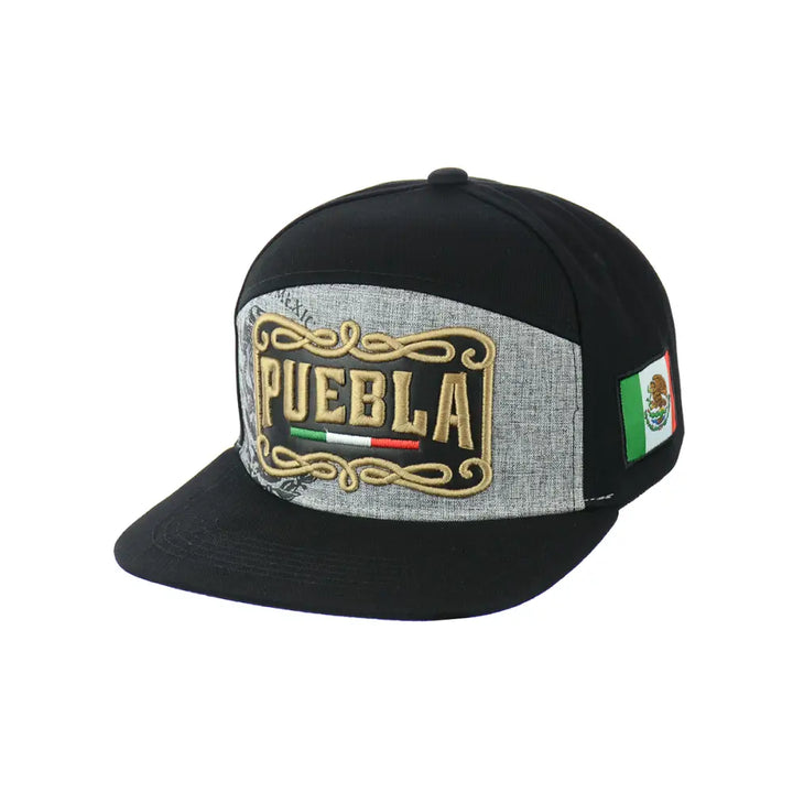 Black snapback hat with a grey front panel featuring gold embroidered 'PUEBLA' text, a small Mexican flag, and decorative scrollwork, displayed against a white background.