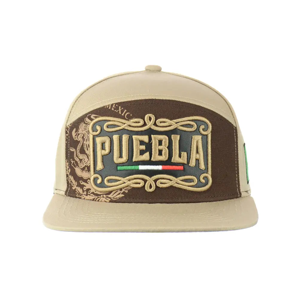 Front view of a beige and dark brown snapback hat featuring 'PUEBLA' embroidered in tan with a Mexican flag stripe, surrounded by ornate scrollwork and 'MEXICO' text.