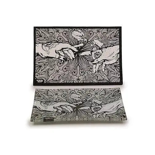 A rectangular black and white mat and a matching clear glass tray, both featuring an intricate 'Creation of Adam' inspired design with hands and floral patterns, displayed on a white background.