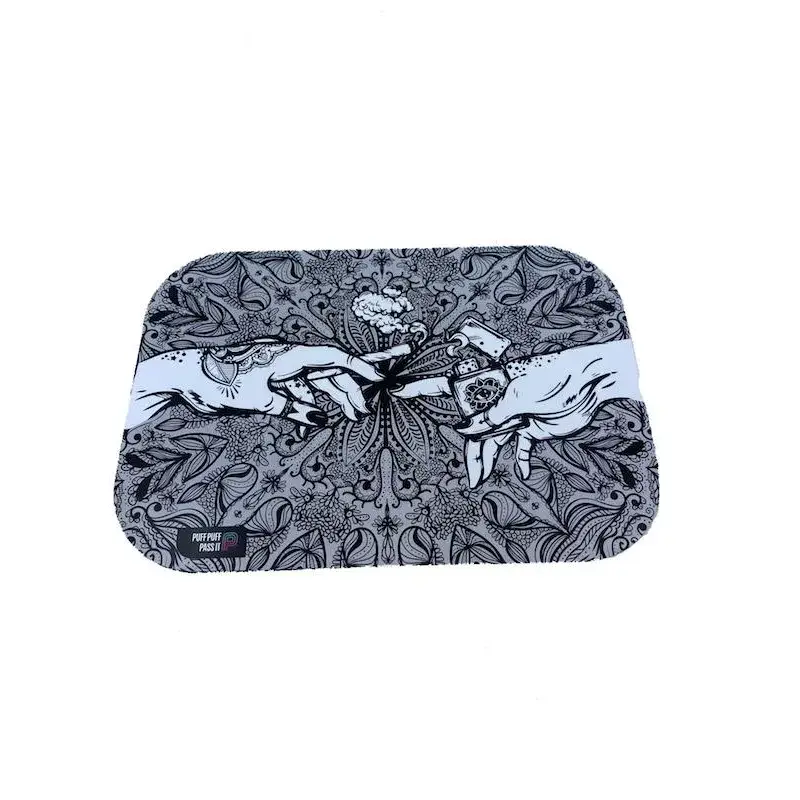 Rectangular metal rolling tray with rounded corners, featuring a black and white illustration of two hands reaching for a lit joint amidst intricate floral and mandala-like patterns. The text 'PUFF PUFF PASS IT' is visible in the bottom left.