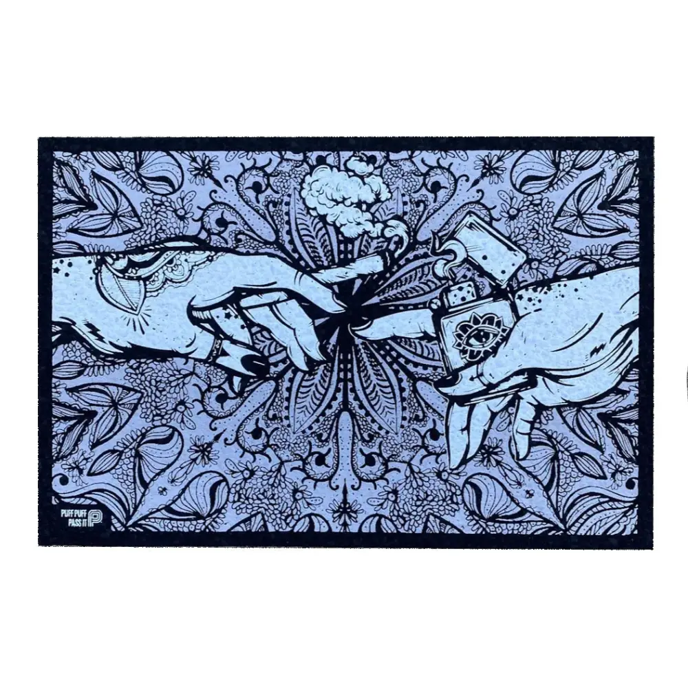 A rectangular mat featuring an intricate illustration of two hands, one holding a lit cannabis joint and the other holding a lighter with an eye symbol, against a detailed floral and paisley background in light blue and dark blue.