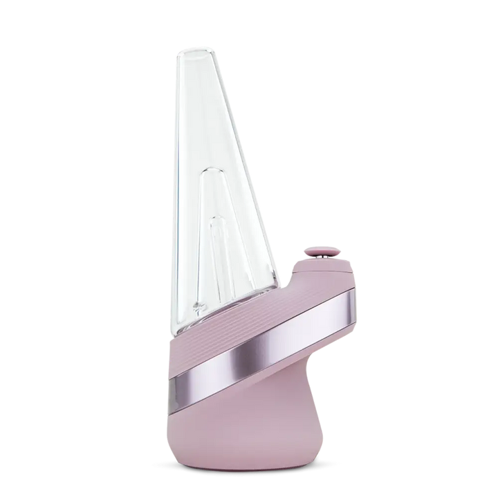 Side view of a blush pink and silver portable vaporizer with a clear, conical glass attachment on top, set against a dark background.