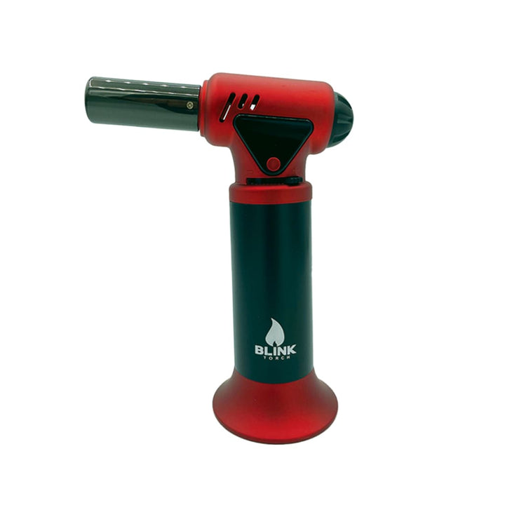 A red and black handheld butane torch with a black nozzle and a red base, featuring a white flame logo and 'Blink Torch' text on the black handle.
