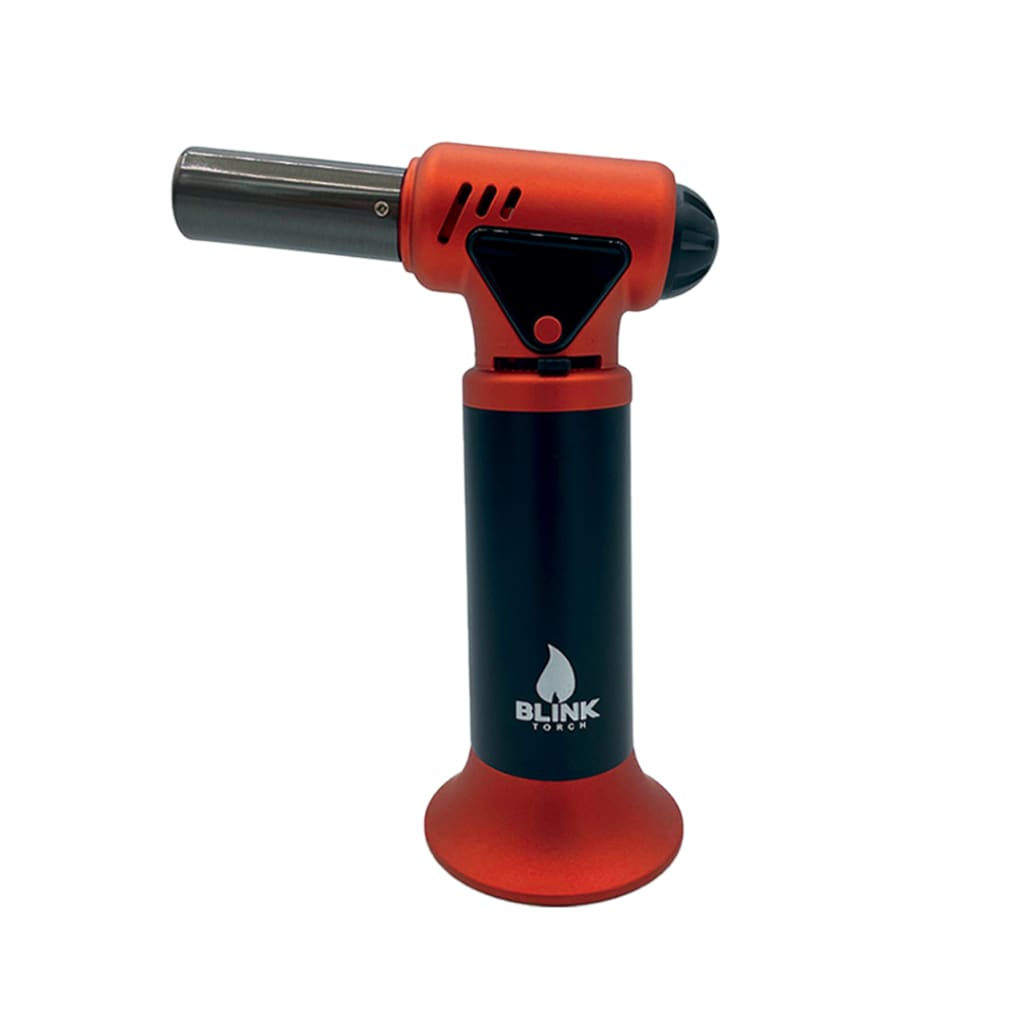 A close-up view of a vibrant orange and black butane torch, featuring a cylindrical base and a horizontal metal nozzle, with the 'Blink Torch' logo visible on the black handle.