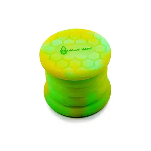 A two-tone green and yellow collapsible silicone jar, featuring a honeycomb texture and an 'ALIENAPE' logo on the lid, shown against a white background.