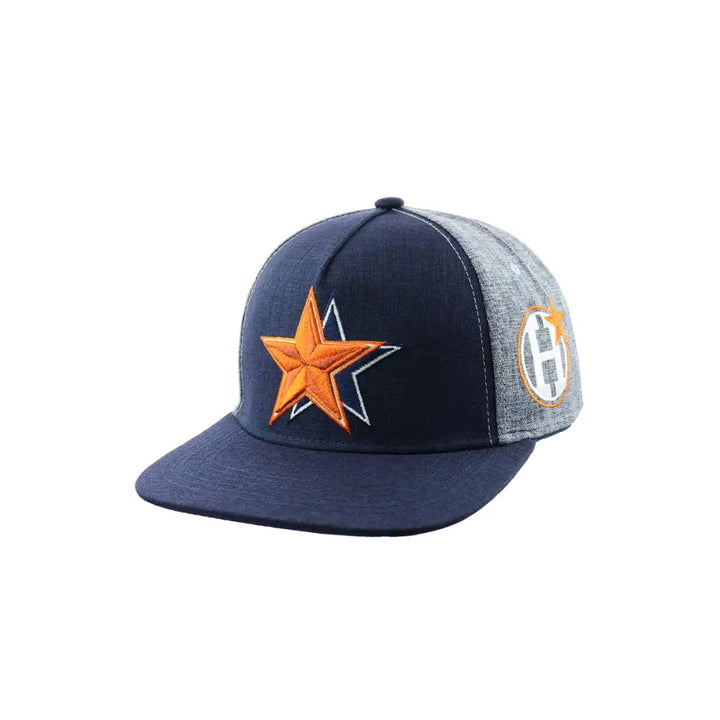 Close-up view of a two-tone snapback hat featuring a dark blue front panel with an orange embroidered star and a light grey side panel with an orange and grey circular logo.