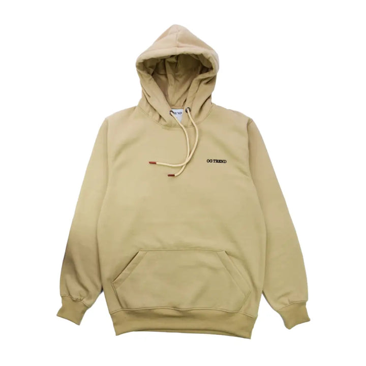 A light beige pullover hoodie with a small black 'OG TREND' logo on the left chest and drawstrings with red tips.