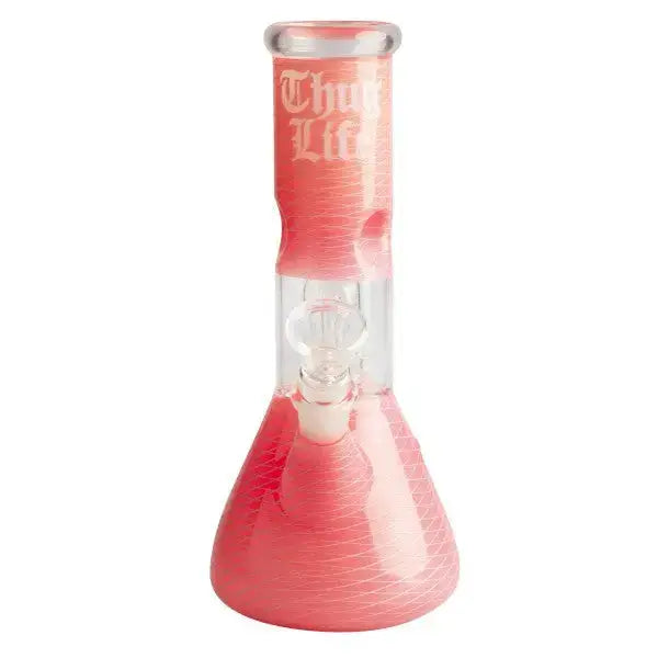 Studio shot of a pink glass water pipe with a beaker base and straight neck, featuring 'Thug Life' text and a subtle geometric swirl pattern.
