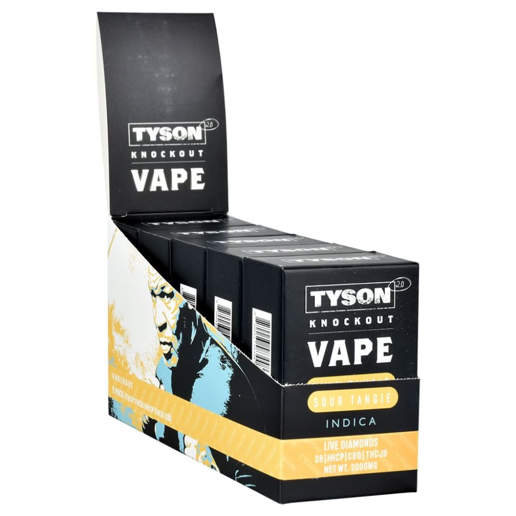 A black and yellow display box filled with Tyson 2.0 Knockout disposable vape pens, featuring a graphic print of Mike Tyson on the side.