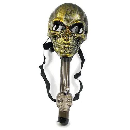 A gold and black skull-shaped gas mask attached to a clear straight tube with a smaller skull at its base, and a black strap.