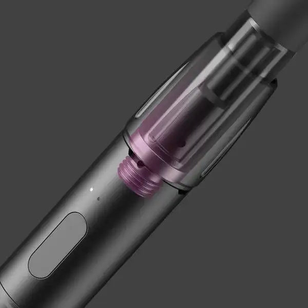 Close-up detail shot of a dark gray vaporizer, revealing the internal purple cartridge and a rectangular button on its side.
