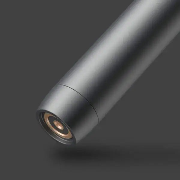 Close-up detail shot of the end of a dark gray cylindrical vaporizer battery, showing the gold-colored electrical contacts for a cartridge.