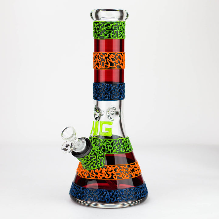 Full product shot of a colorful beaker bong with red, orange, blue, and neon green striped sections, featuring a glow-in-the-dark logo and textured patterns.